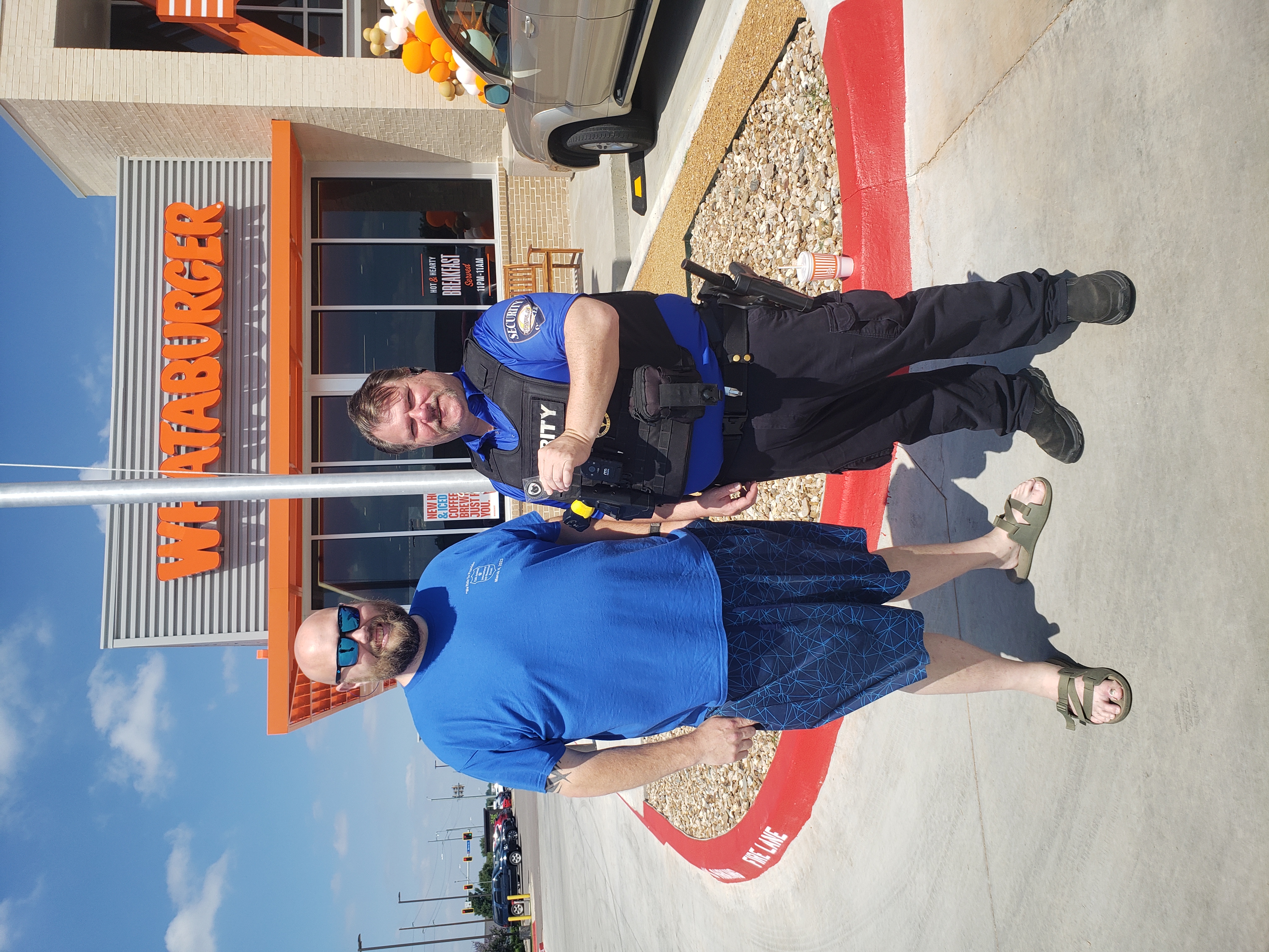 Johnny being presented with a challenge coin by a Whataburger patron